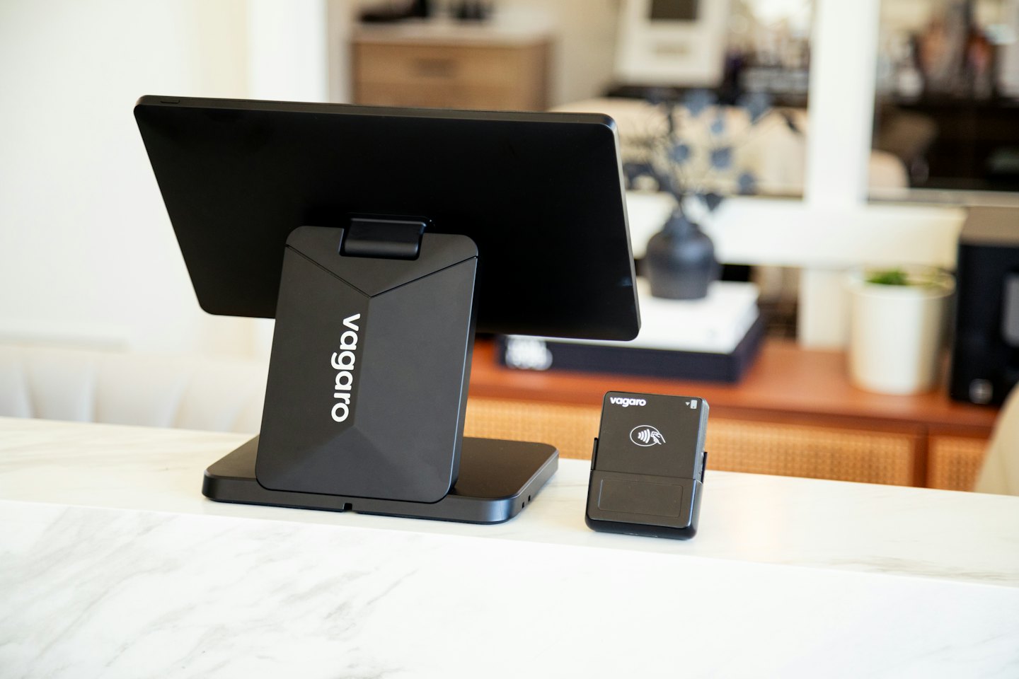 Point of sale system and card reader on white marble.