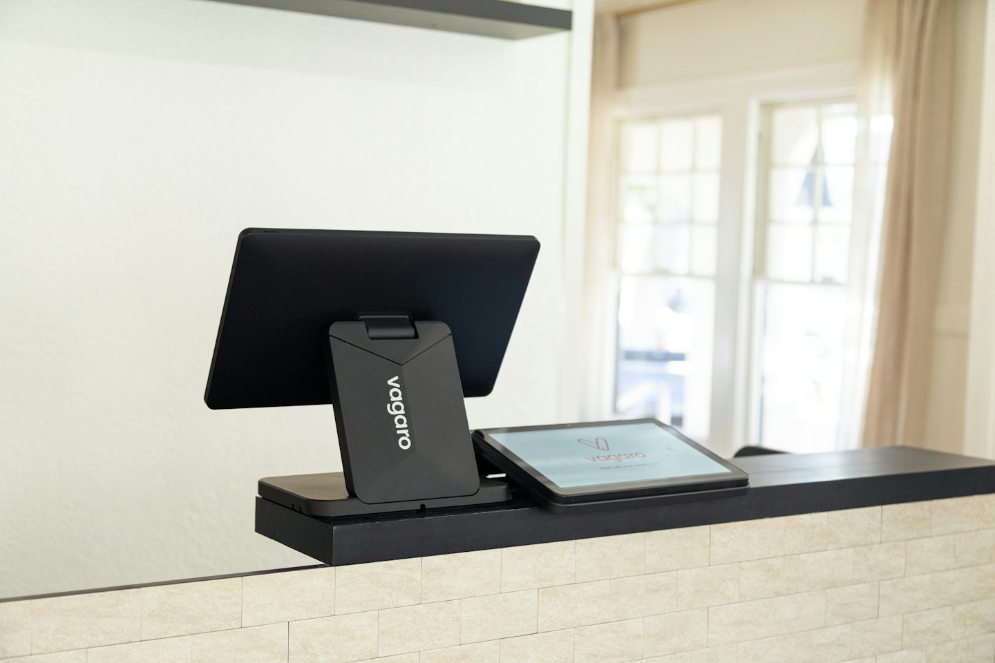 Modern digital point of sale system on a reception counter.