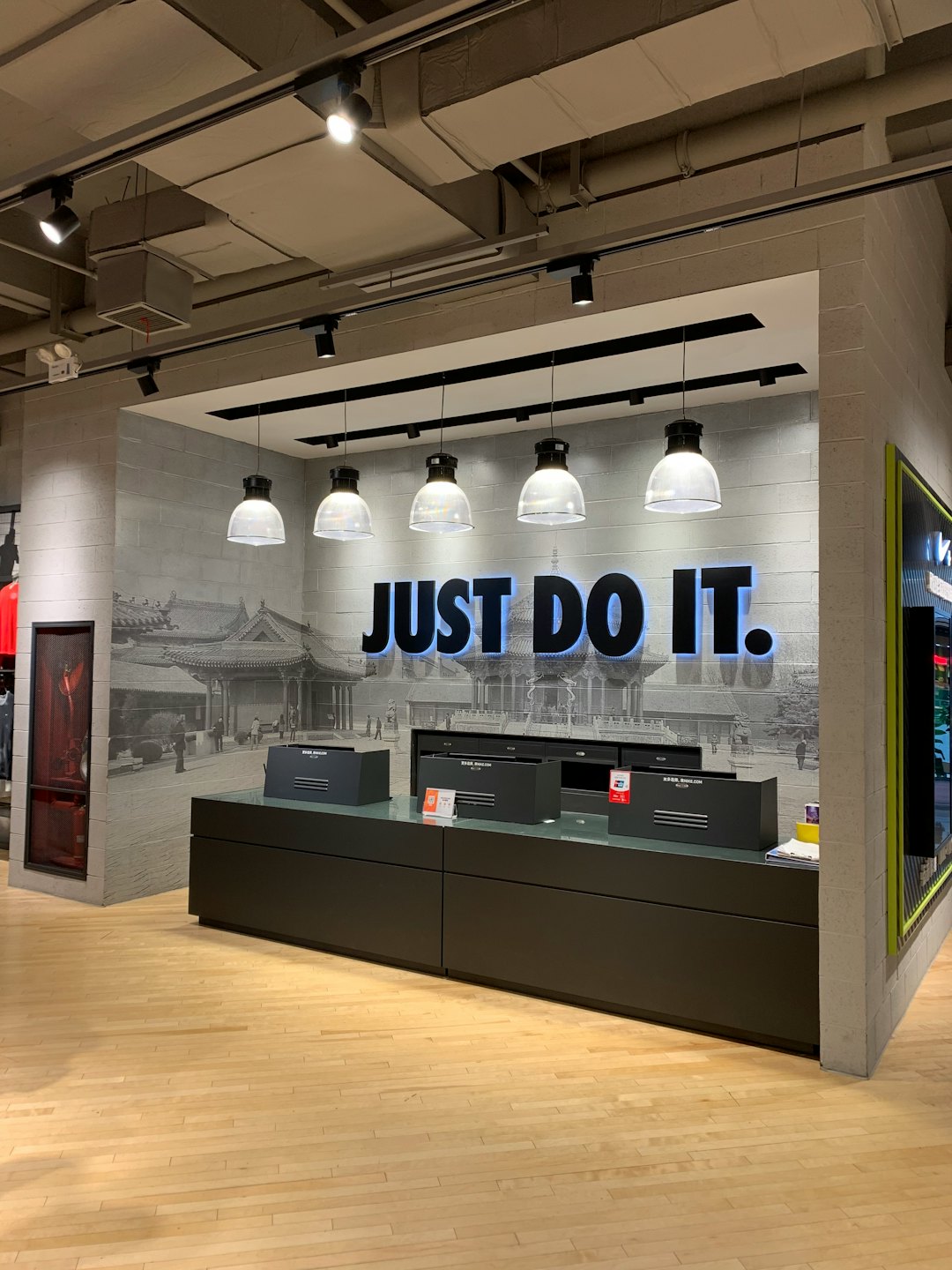Retail store checkout counter with a wall sign and mural.
